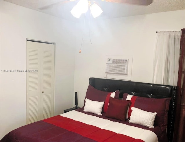 bedroom featuring ceiling fan, a wall mounted AC, and a closet