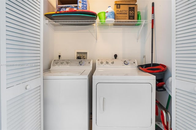 laundry room with electric dryer hookup, hookup for a washing machine, and separate washer and dryer