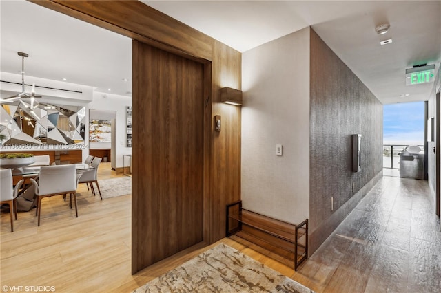 corridor with light hardwood / wood-style flooring