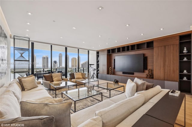 living room with floor to ceiling windows and light hardwood / wood-style flooring