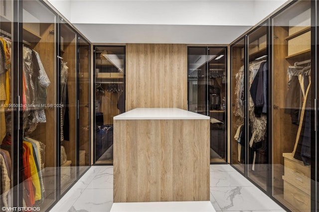 walk in closet featuring light tile floors