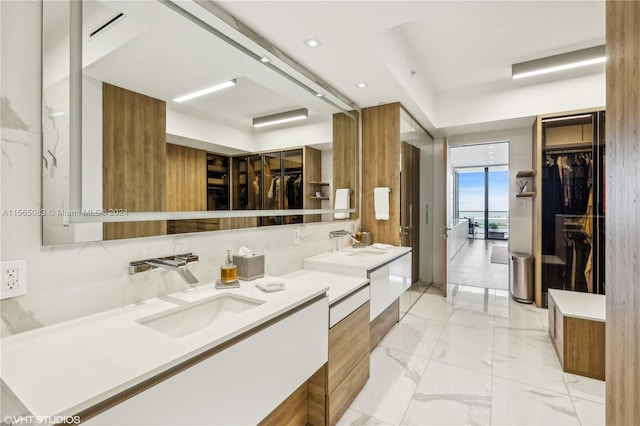 bathroom featuring tasteful backsplash, tile flooring, and double sink vanity