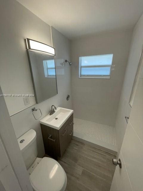 bathroom featuring hardwood / wood-style flooring, toilet, and vanity