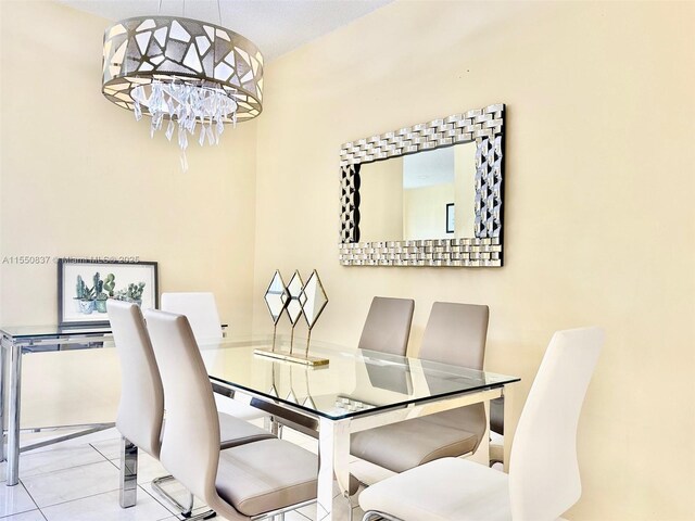 tiled living room with a textured ceiling and an inviting chandelier