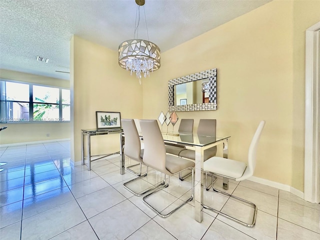 living room featuring light tile flooring, a chandelier, and a textured ceiling