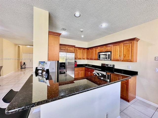 tiled dining space with a textured ceiling and a chandelier