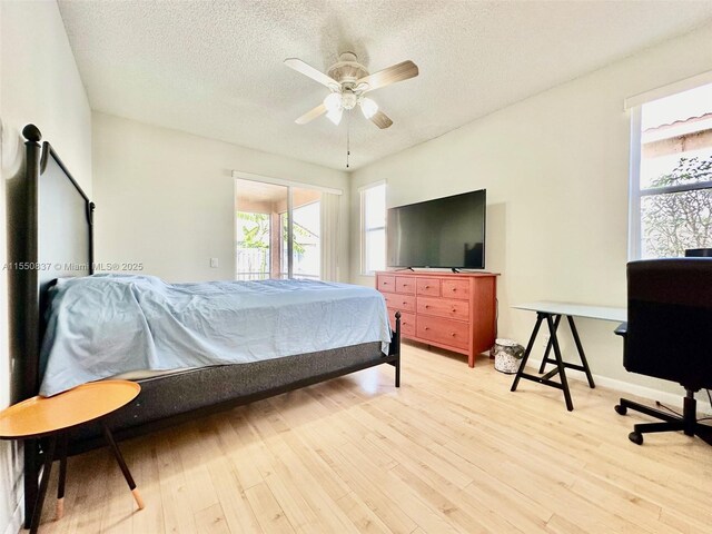 kitchen featuring ceiling fan, light tile floors, stainless steel dishwasher, kitchen peninsula, and a wealth of natural light