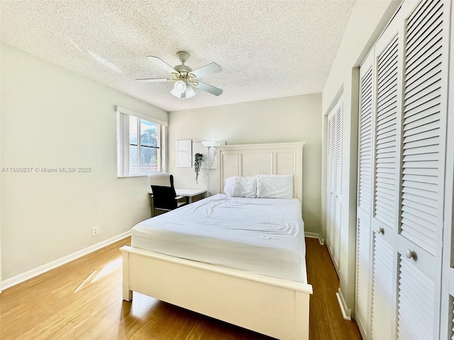 hall featuring light hardwood / wood-style floors and a textured ceiling