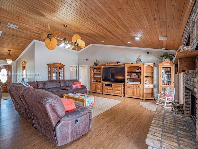 living room featuring wooden ceiling, ceiling fan, wood-type flooring, a fireplace, and ornamental molding