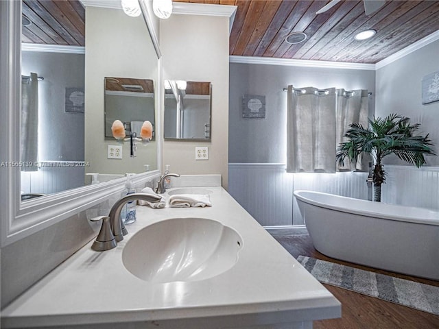 bathroom with ceiling fan, vanity with extensive cabinet space, wood ceiling, ornamental molding, and hardwood / wood-style flooring