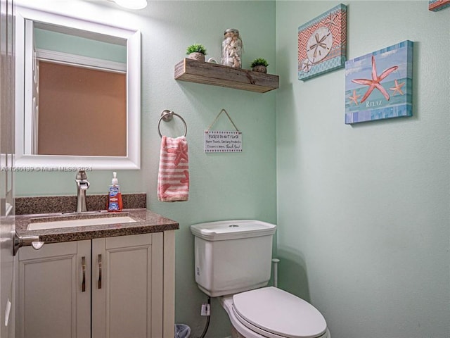 bathroom with toilet and vanity