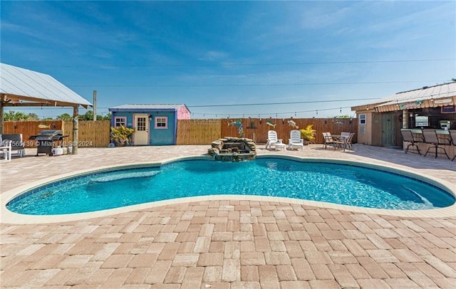 view of pool with an outdoor structure and a patio