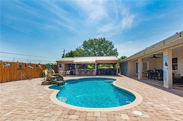 view of swimming pool with a patio area, ceiling fan, and a gazebo