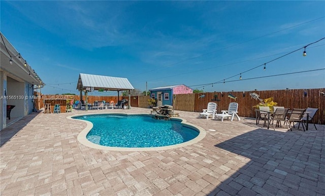 view of pool featuring a patio area and an outdoor structure