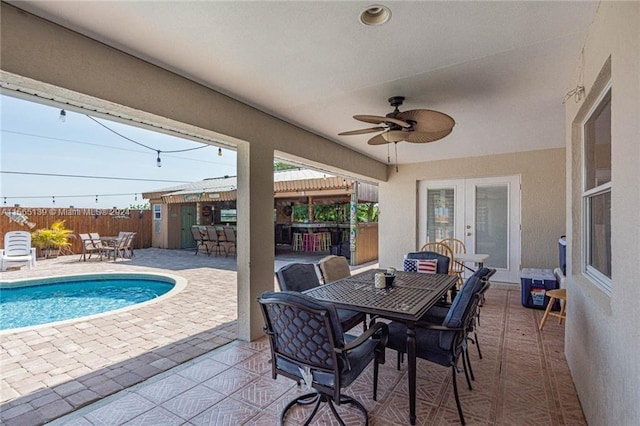 view of patio with ceiling fan and a fenced in pool