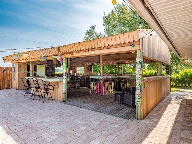 view of patio / terrace with an outdoor bar and a wooden deck