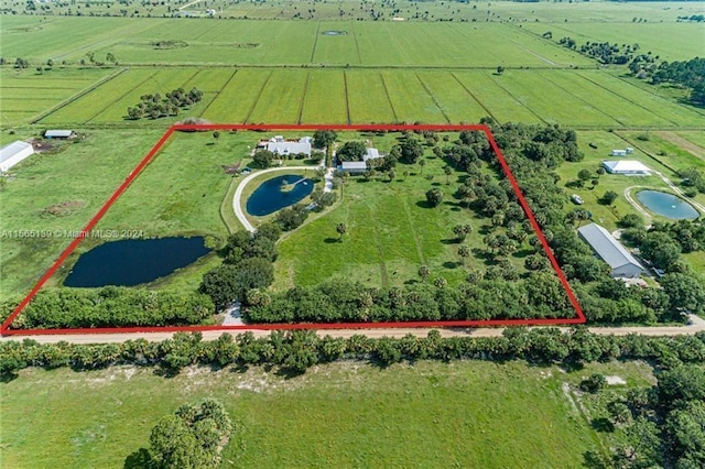 bird's eye view featuring a rural view and a water view