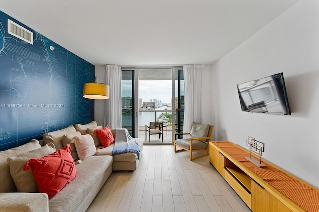 living room with expansive windows and light wood-type flooring