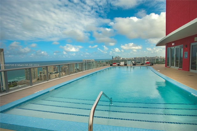 view of pool featuring a water view