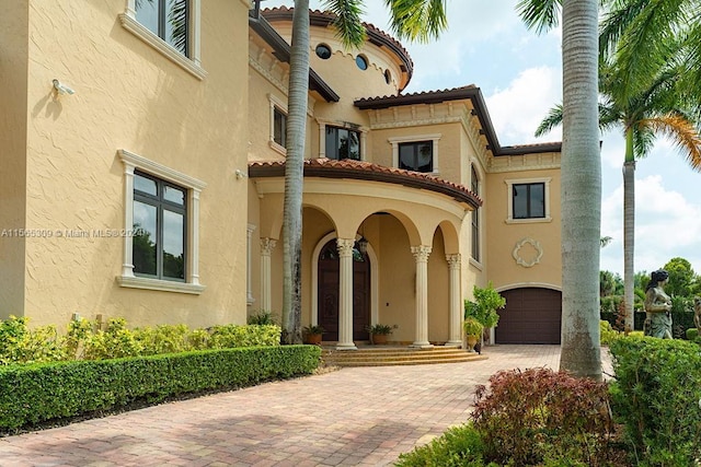 mediterranean / spanish home featuring a garage