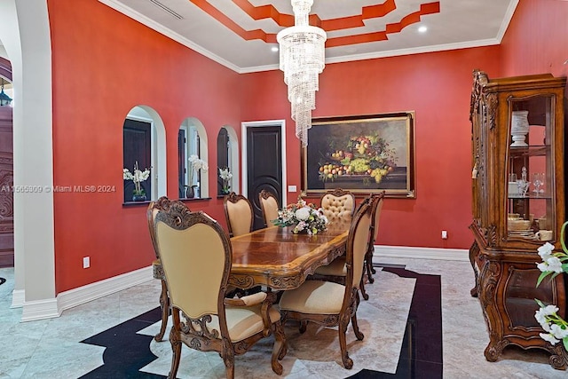 dining room featuring an inviting chandelier, ornamental molding, and light tile flooring