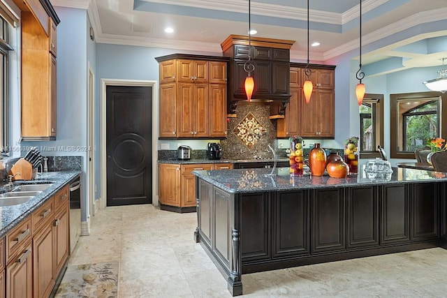 kitchen with hanging light fixtures, a center island with sink, a tray ceiling, and light tile floors