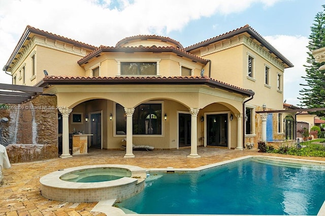 back of house with a patio area and a swimming pool with hot tub