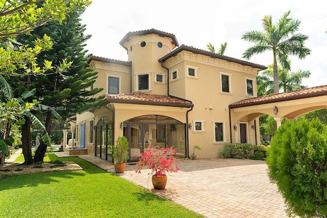 view of front of home with a front lawn and french doors