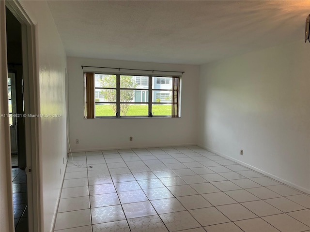 spare room featuring light tile floors