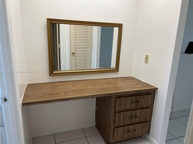 bathroom with tile flooring and vanity