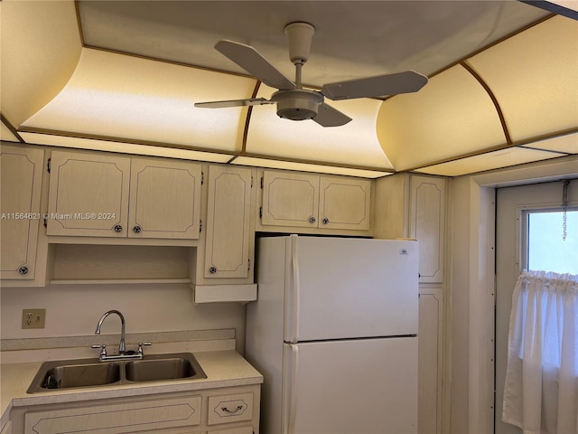 kitchen featuring ceiling fan, sink, and white refrigerator