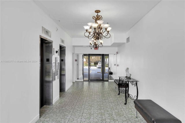 hall with an inviting chandelier, tile floors, and elevator