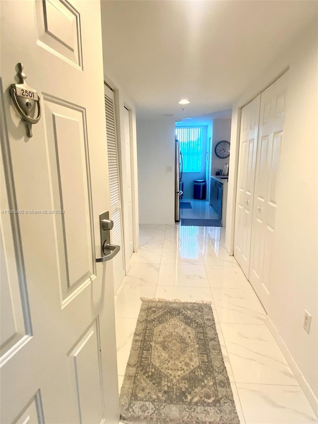 hall featuring light tile floors