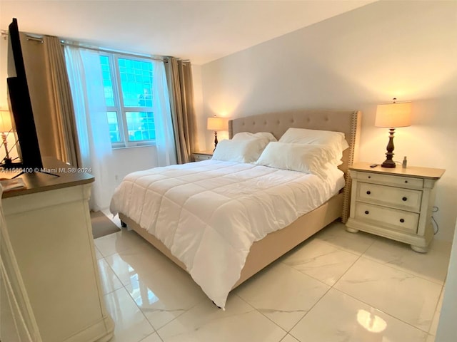 bedroom with light tile flooring