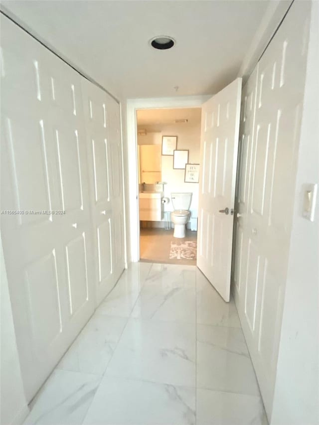 hallway featuring light tile flooring