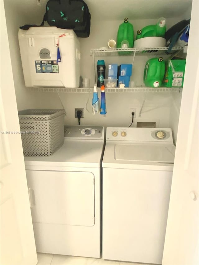 washroom featuring washing machine and dryer, hookup for an electric dryer, and light tile flooring