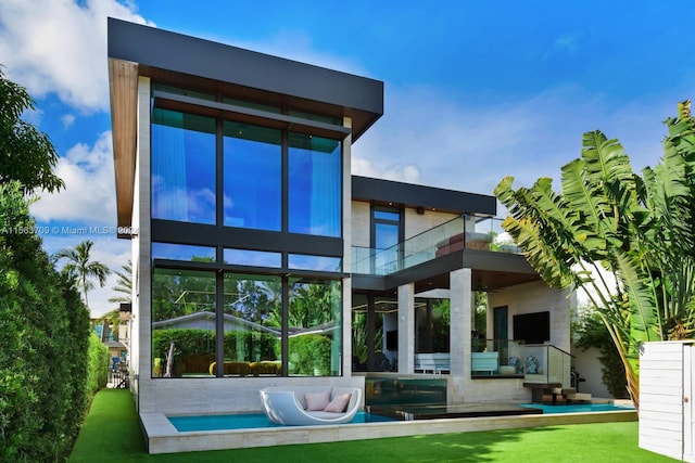 rear view of property with a balcony