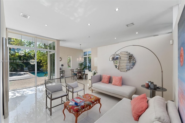 living room featuring floor to ceiling windows and a notable chandelier