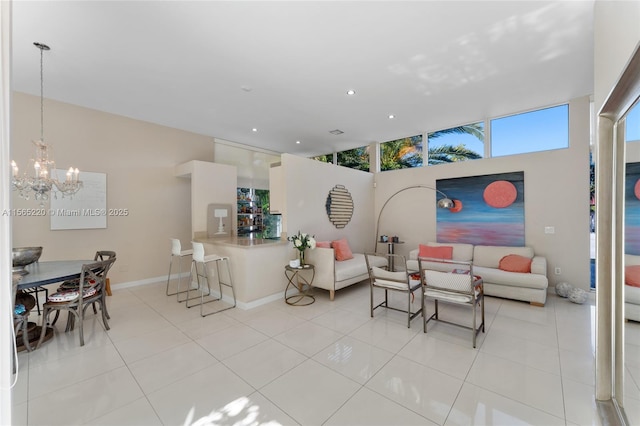 living room with a notable chandelier and light tile patterned floors