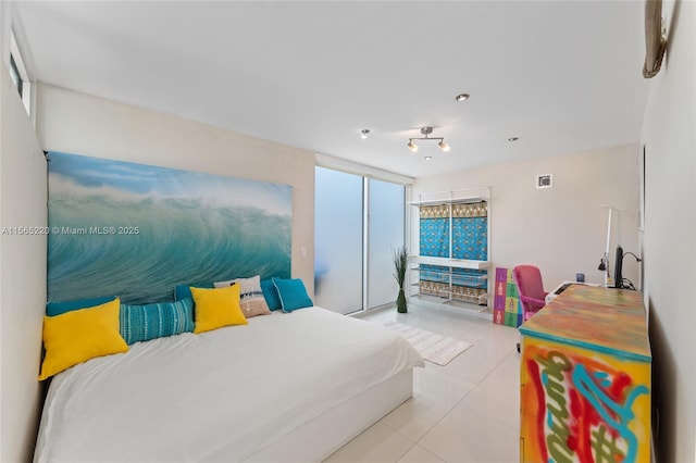 bedroom featuring multiple windows and light tile patterned floors