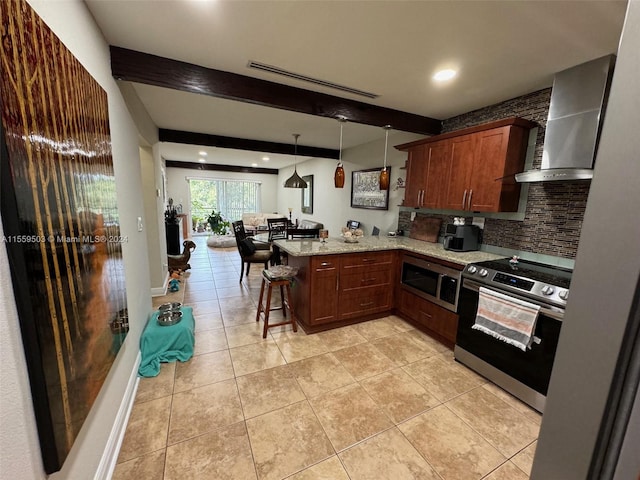 kitchen with appliances with stainless steel finishes, kitchen peninsula, light stone countertops, wall chimney exhaust hood, and hanging light fixtures