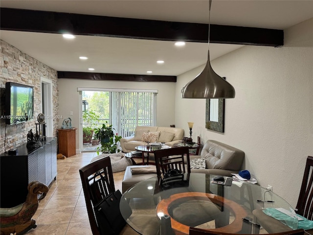 dining room with light tile floors and beamed ceiling