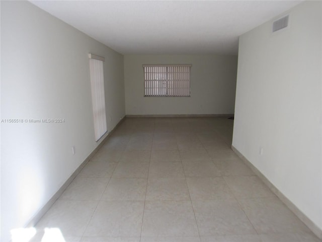 empty room with light tile patterned floors