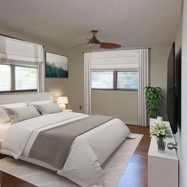 bedroom featuring a textured ceiling, wood-type flooring, and ceiling fan