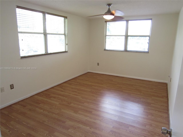 unfurnished room featuring hardwood / wood-style floors and ceiling fan