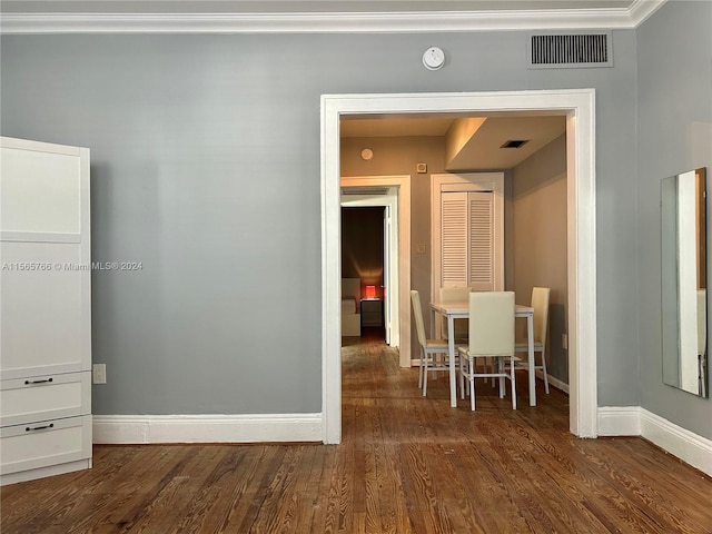 interior space featuring crown molding and dark hardwood / wood-style flooring