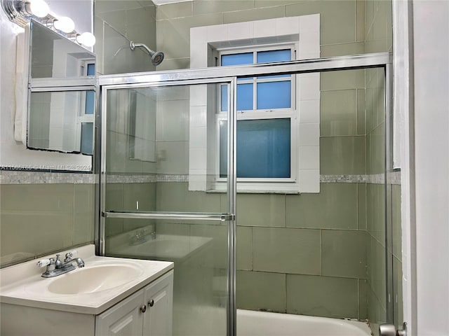 bathroom with vanity and shower / bath combination with glass door