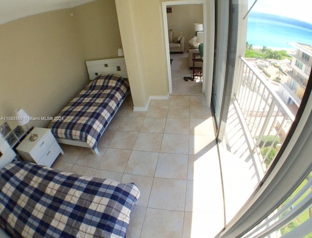 bedroom with light tile flooring and multiple windows