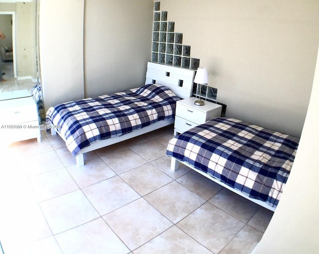 bedroom with light tile floors