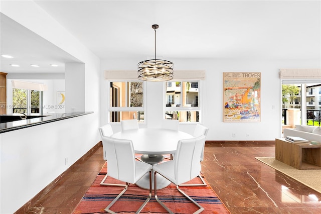 dining area with plenty of natural light and an inviting chandelier